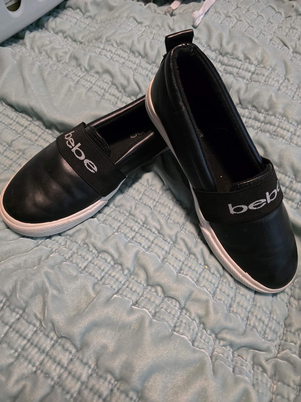 Bebe girls' slip-on sneakers in black with a prominent white sole